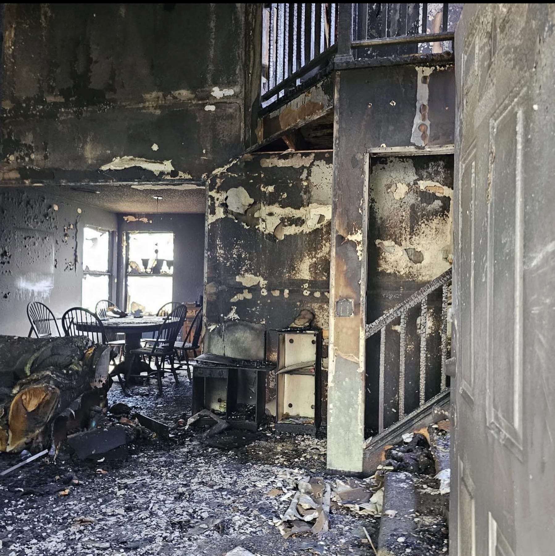 Home interior with charred walls and furniture after a fire
